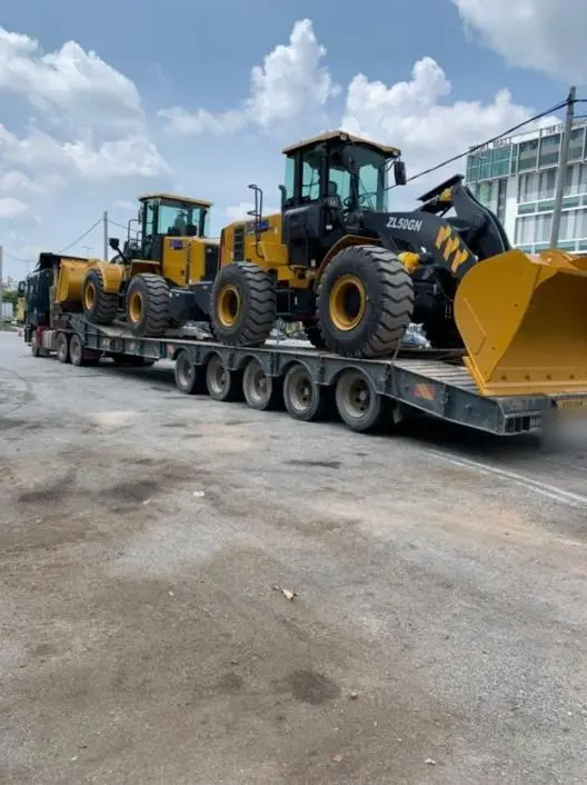 Wheel loaders on a low loader